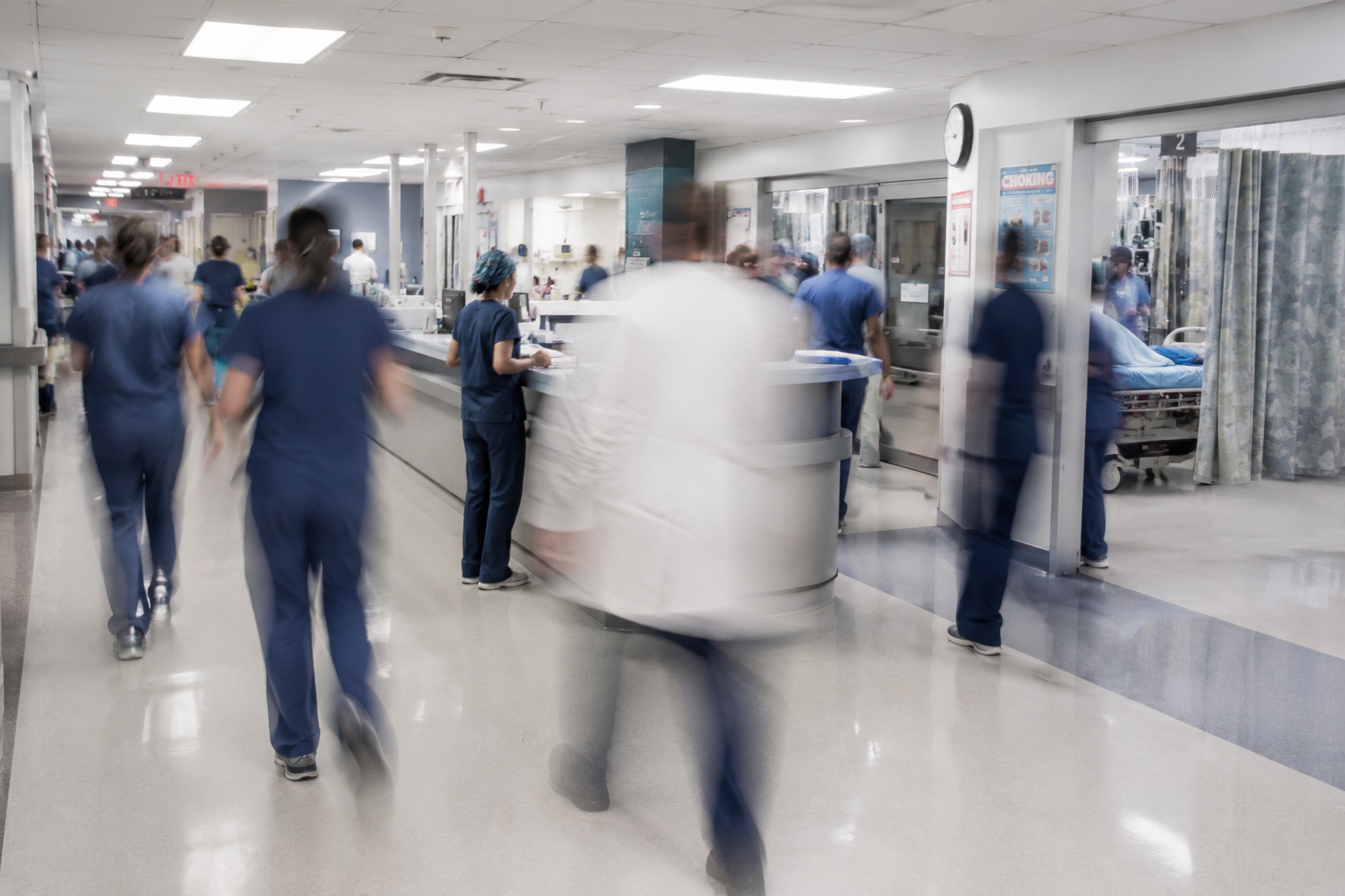 blurred over-exposure image of busy hospital interior