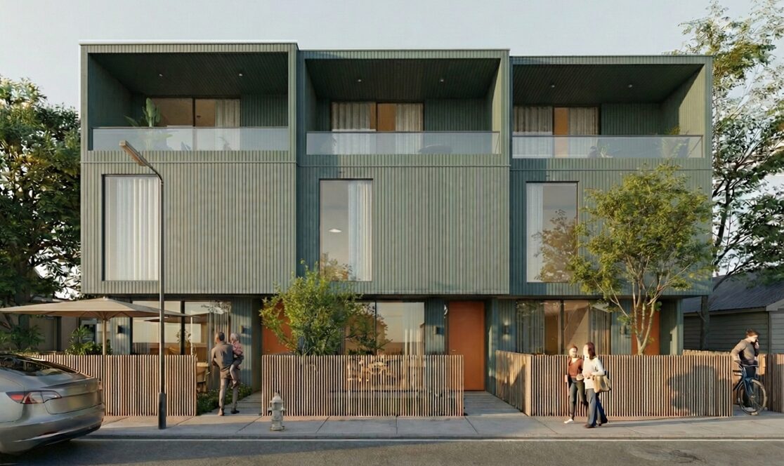 front view of the modular homes with green slat siding and front yard fences