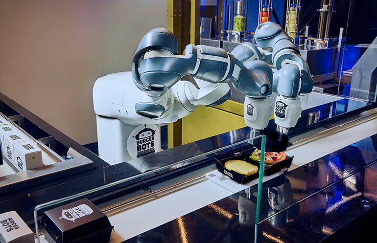 Burger Bots assembling a meal in live production.