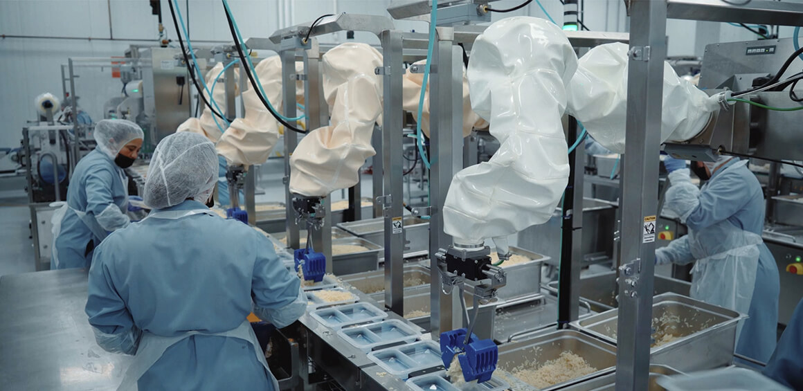 Chef robots working along side human food workers to provide automated portion control.