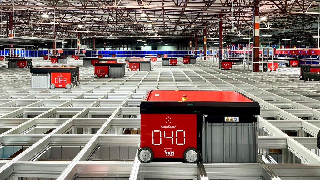 AutoStore autonomous robot operating atop the storage grid to retrieve and transport inventory bins.