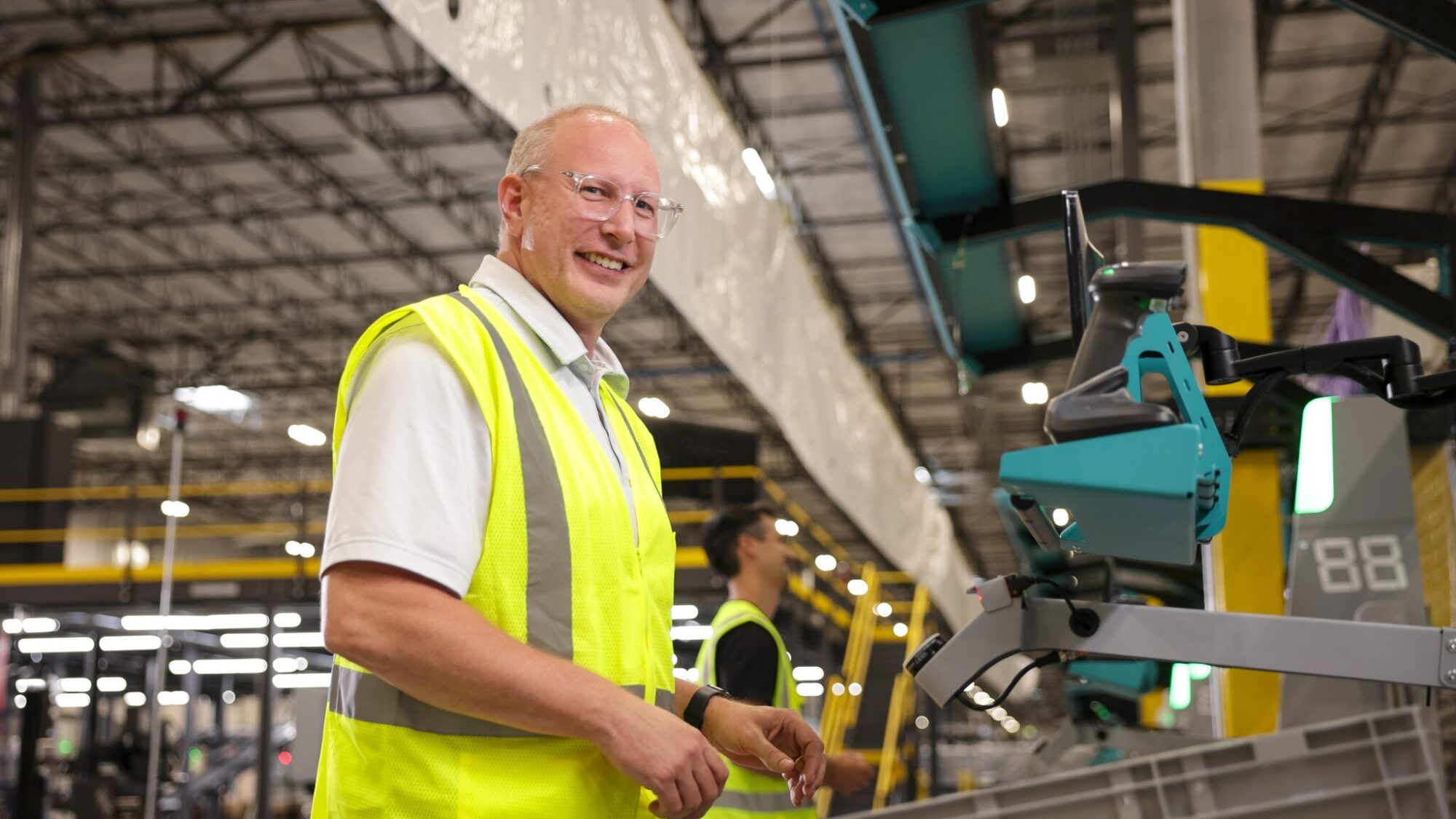 Technician working at an industrial automation station to monitor and manage automated production processes.