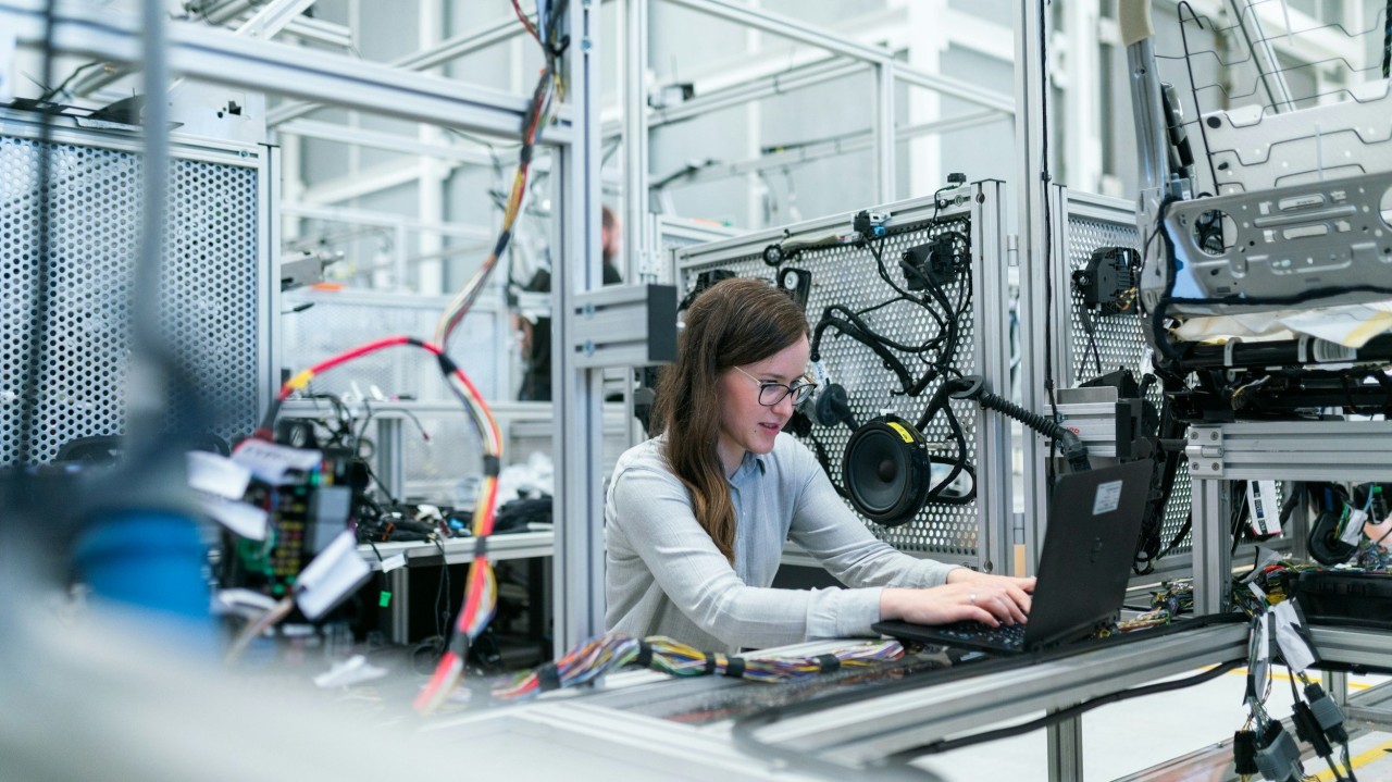 Technician programming and configuring an industrial automation system for efficient operation and control.