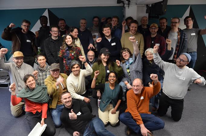 Technology cooperative members connecting and sharing ideas during a 2025 gathering at Outlandish.